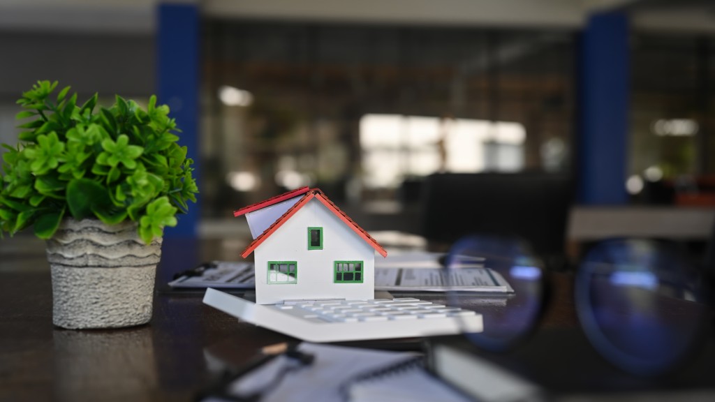 Small home model, documents and calculator on black table. Real