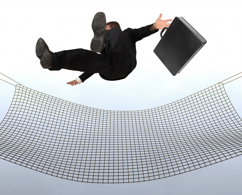 Businessman falling the Sky into a safty net