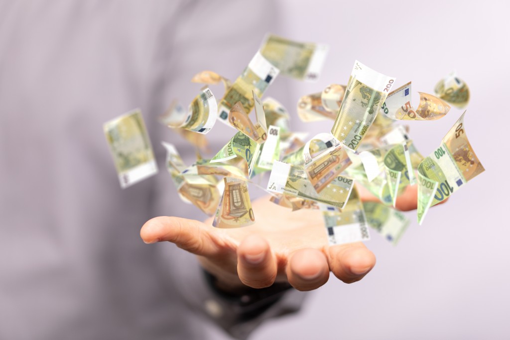Man hand on blurred background holding cashflow euro banknote bill in hand