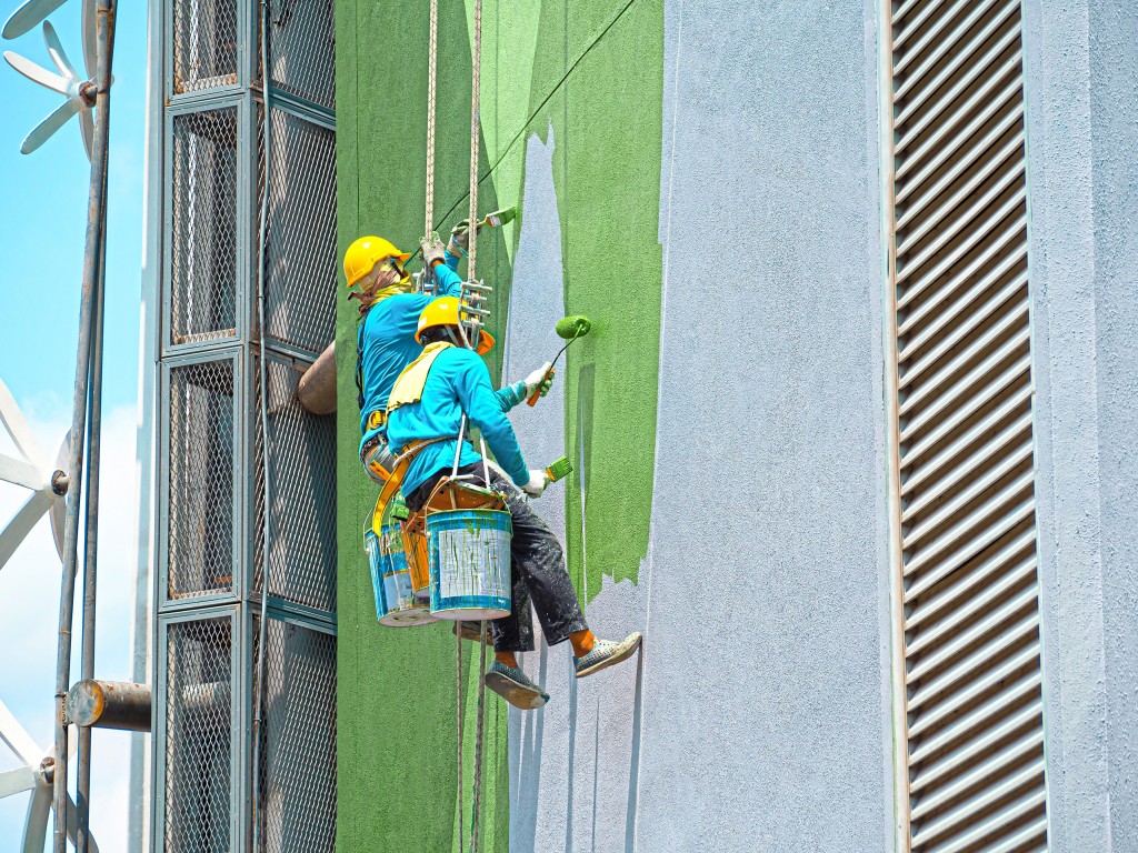 Painters painting exterior of building