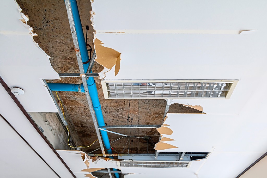 repair leak water pipe on gypsum ceiling interior office buildin